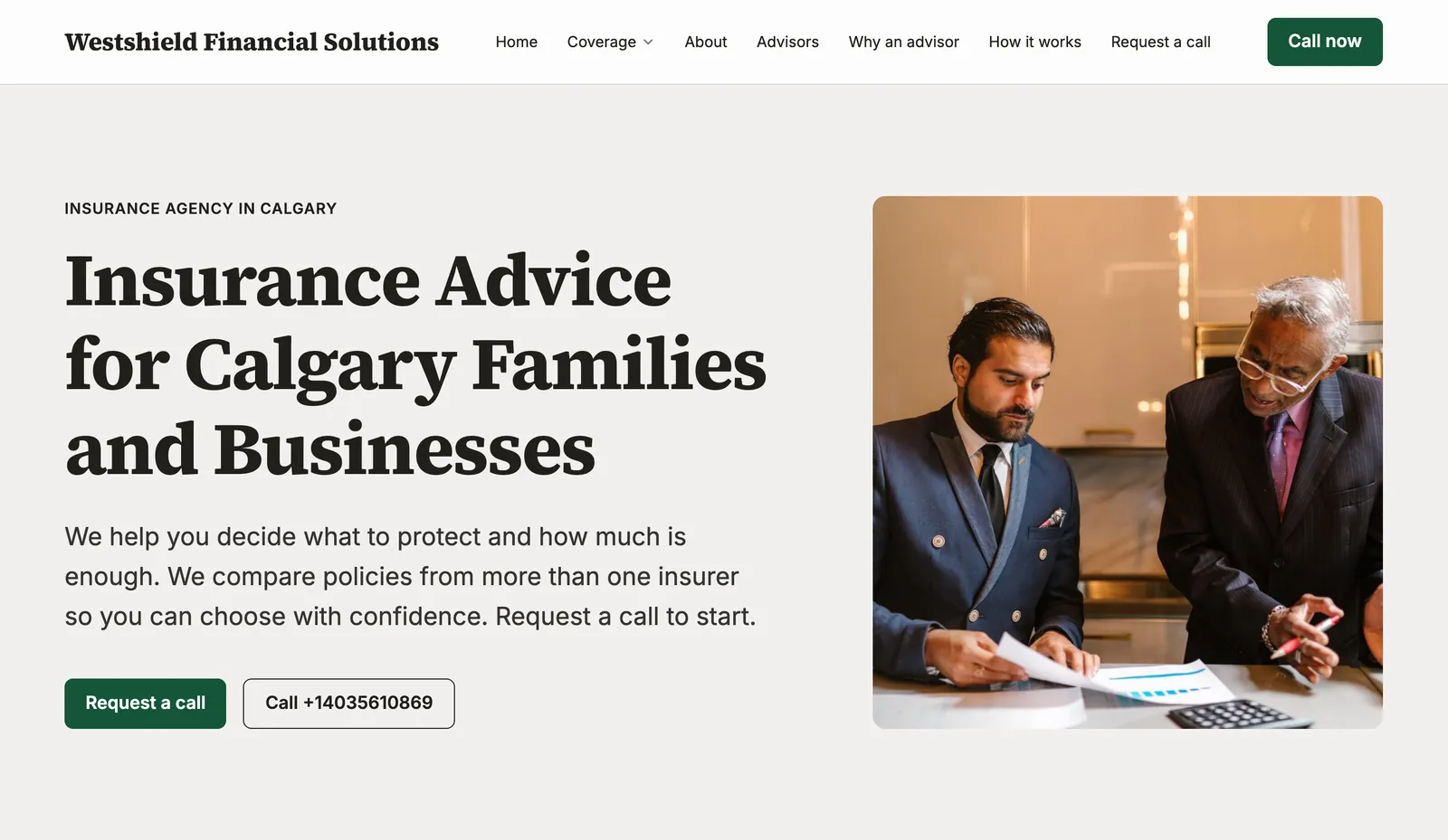 The home page of an insurance agency's website made with Mainmark: insurance advice for families and businesses, beside a photograph of two advisors reviewing a policy